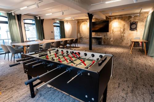 a room with a table and a large foos ball at Restaurant Hotel Zum Storchen in Waldkirch