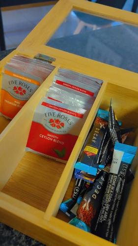 a wooden box filled with toothbrushes and toothpaste at WeMukelekile (you are welcome) in Lobamba