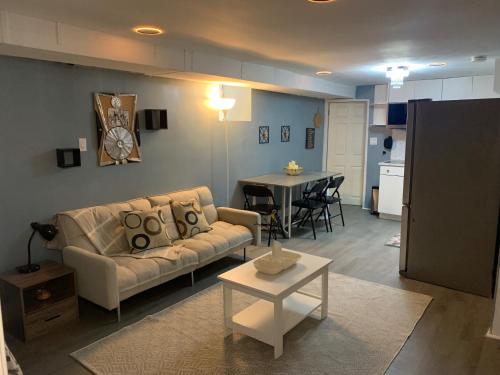a living room with a couch and a table at Suhira Hospitality Group in Lansdowne