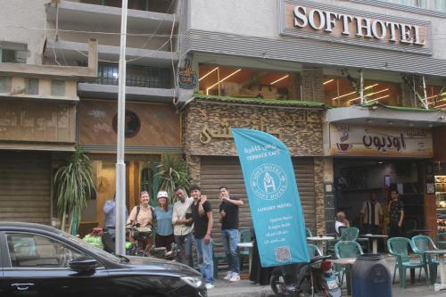 a group of people standing in front of a restaurant at Soft Hotel in Cairo