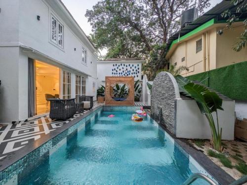 a swimming pool in the backyard of a house at Villa Candolim in Candolim