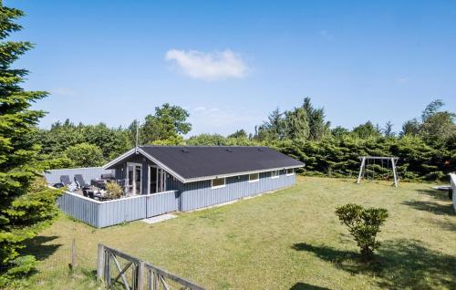 a house in a yard with a fence at 3 Bedroom Nice Home In Fjerritslev in Fjerritslev