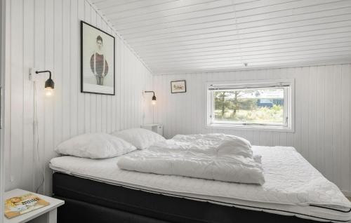 a bed in a white room with a window at 3 Bedroom Nice Home In Fjerritslev in Fjerritslev