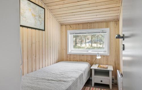 a small bedroom with a bed and a window at 3 Bedroom Nice Home In Fjerritslev in Fjerritslev