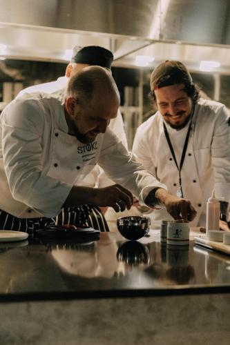 a group of three chefs preparing food in a kitchen at Radisson Collection The National Hotel, Brussels in Zaventem