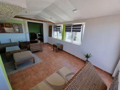 an empty living room with chairs and a table at Apartma Olivia in Šmarje