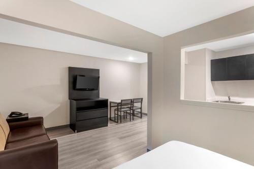 a room with a couch and a television and a chair at MainStay Suites Little Rock West Near Medical Centers in Little Rock
