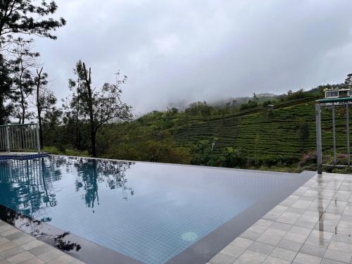 a swimming pool with a view of a mountain at Falcon Crest in Vagamon