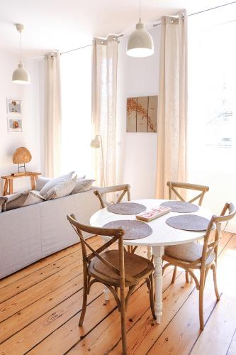 a living room with a table and chairs and a couch at Bordeaux Village Blaye in Blaye