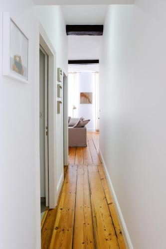 an open hallway with wood floors and a living room at Bordeaux Village Blaye in Blaye