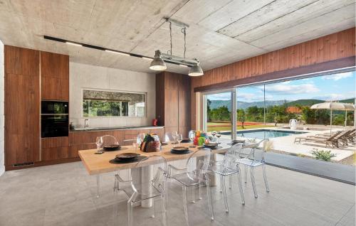 a kitchen with a table and chairs and a pool at Beautiful Home In Dicmo in Dicmo