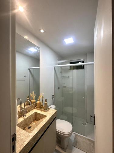 a bathroom with a sink and a toilet and a shower at Casa Caju Lençóis in Barreirinhas