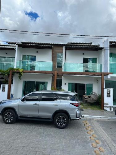 a silver suv parked in front of a house at Casa Caju Lençóis in Barreirinhas