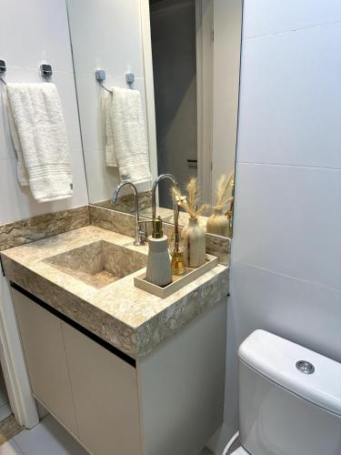 a bathroom with a sink and a toilet at Casa Caju Lençóis in Barreirinhas