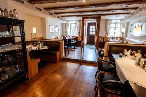 a restaurant with tables and chairs in a room at Restaurant Hotel Zum Storchen in Waldkirch