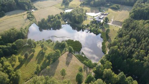 an aerial view of a lake in a field at Camp & Dolidkowo in Gwieździn