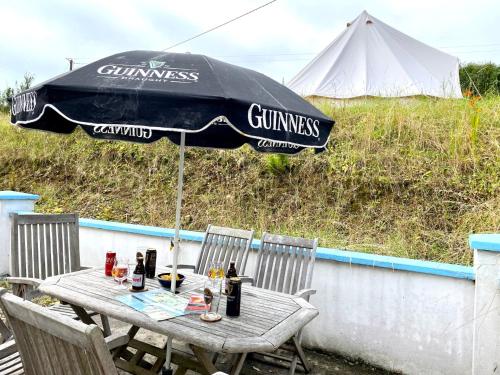 a table with an umbrella on a patio at Bikes Beers Bed and Breakfast 