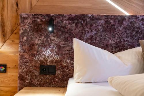 a bed in a room with a wall at Hotel Rose in Mayrhofen