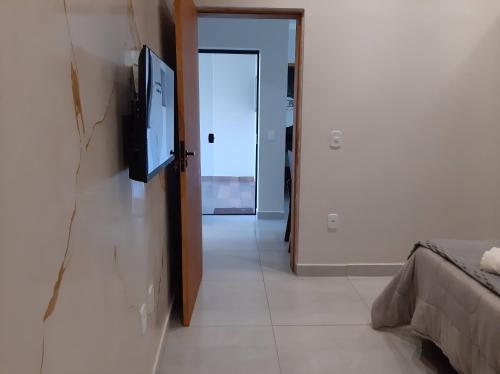 a hallway with a flat screen tv on a wall at Casa Lara in Cunha