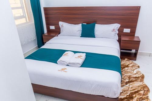 Ένα ή περισσότερα κρεβάτια σε δωμάτιο στο Executive 1BR Apartment in Elgonview close to Reale Hospital