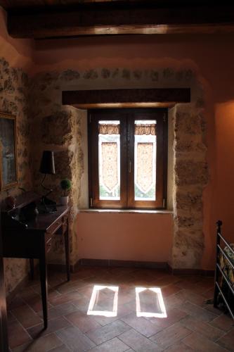 a room with a window and a desk and a table at Agriturismo Le Faeta in Arpino