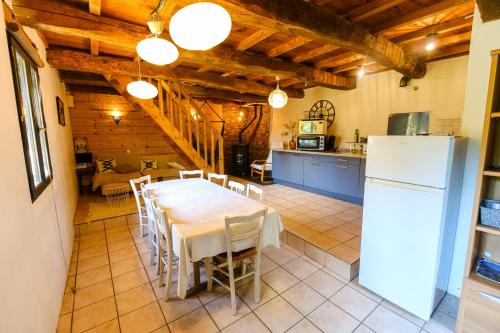 a kitchen and dining room with a table and a refrigerator at La montana in Seix