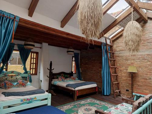 a bedroom with two beds in a room at Usaquen Casa vintage La flor del callejon in Usaquén