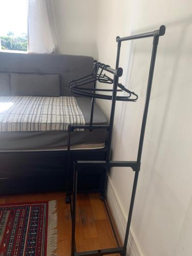 a bunk bed with a ladder next to a wall at Quartos Vila Augusta/Guarulhos in Guarulhos