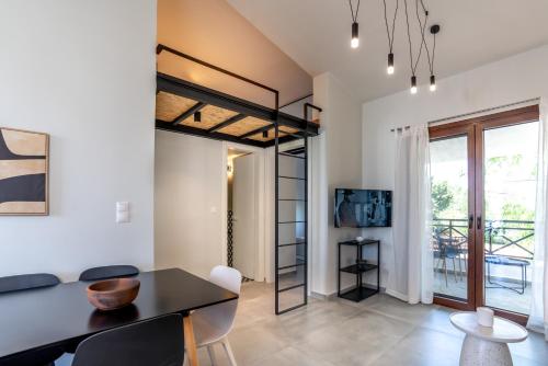 a room with a loft bed and a dining room at Semeli Lux apt, Siviri in Siviri