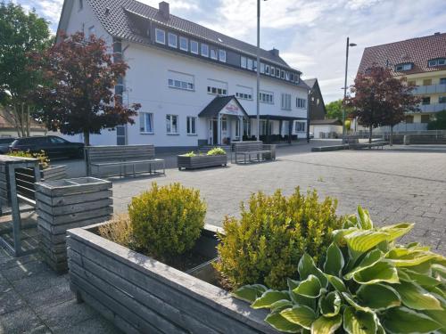 a large white building with benches in a courtyard at Apollo Home - Deine Base im Grünen in Wildflecken