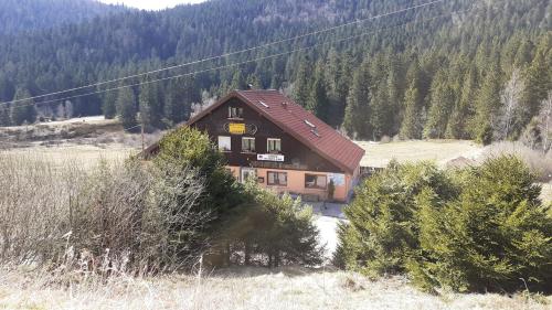 a house in the middle of a field with trees at Domaine Des Hauts Viaux in La Bresse