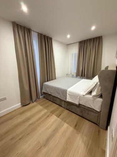 a bedroom with a bed and a large window at Luxury Sovereign House in Brighouse