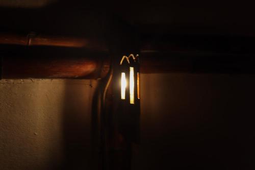 a close up of a candle in the dark at Habitación grupal en San Carlos con acceso al rio y desayuno incluido in San Carlos