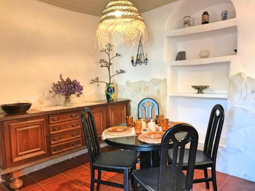 a dining room with a table and chairs at La Buganvilla del Pazo in Níjar