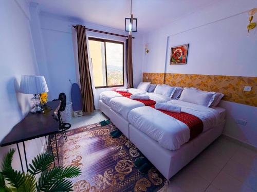 a large bed in a room with a window at Ngong Hills View in Ngong