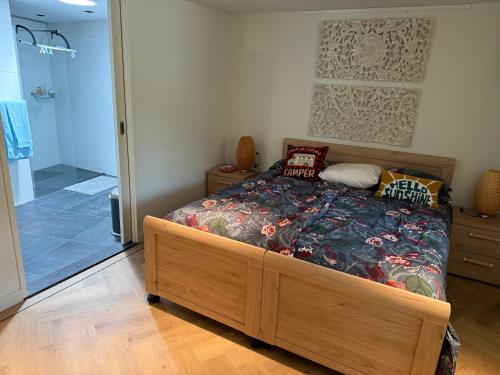 a bedroom with a bed and a walk in shower at Maison Lelystad in Ons Belang