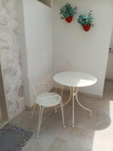 a table and two chairs and a table and a table and chair at Zia Giacomina's House in Cassano delle Murge