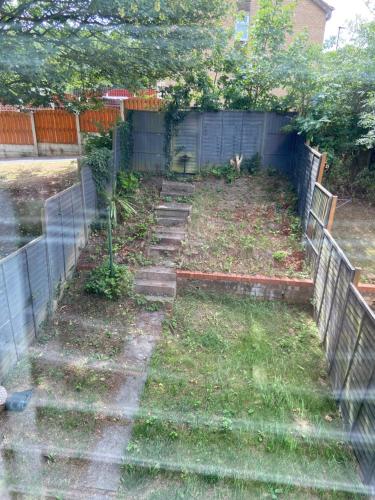 a garden with stairs and a fence at Garland way 2 bed house Sheffield free parking 5 min from m1 in Mosborough