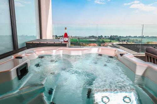 a jacuzzi tub in a room with a view at Yalarent C Kinneret Apartments With Private Jacuzzi in Migdal
