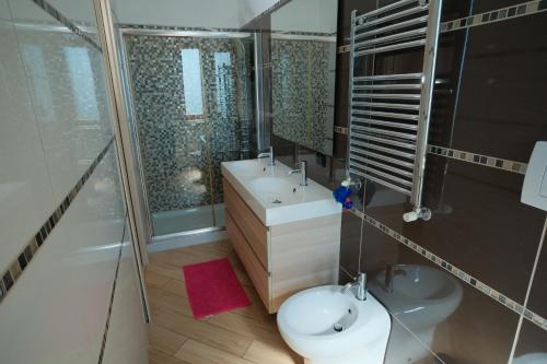 a bathroom with a toilet and a sink and a shower at Residenza S anna in Rocca Cilento