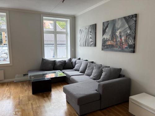 a living room with a couch and a table at Down Town Arendal in Arendal