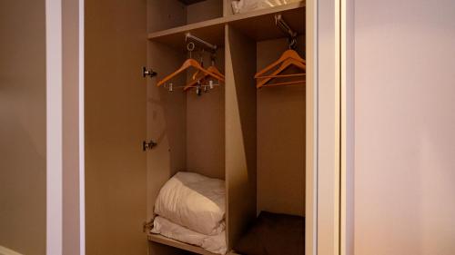 a closet with a mirror and hangers in it at Alliance Palace Seaside in Batumi