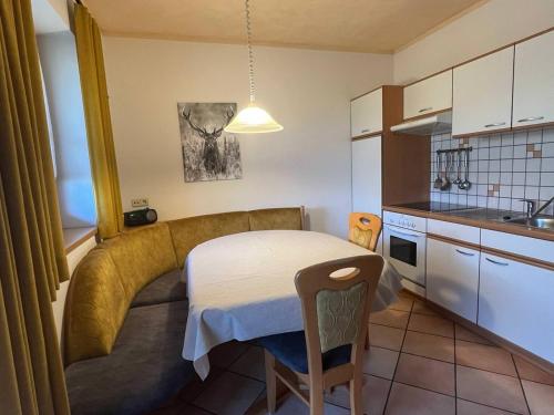 a small kitchen with a small table in a room at Bruneggerhof Weissenbach in Rio Bianco