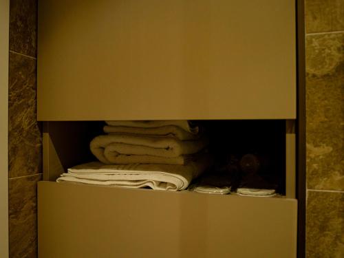 a closet with a bunch of towels in it at Alliance Palace Seaside in Batumi