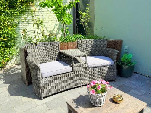 two wicker chairs and a table on a patio at Boutique Hotel Joure - centrum & haven in Joure