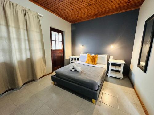 a bedroom with a bed with a teddy bear on it at Aruwaa in East London