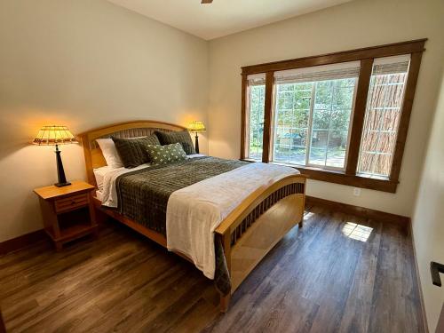 a bedroom with a large bed and a window at 56 Black Bear Bungalow in North Wawona
