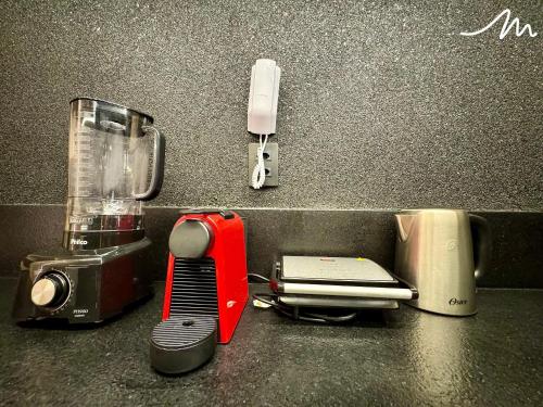 a kitchen counter with a blender and other appliances at Move - Tambaú in Tambaú