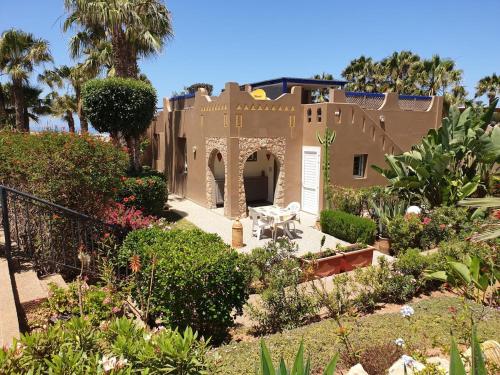 a house in the middle of a garden at Villa bord de mer, piscine, fibre internet, Sidi Boulfdail, Mirleft in Mirleft