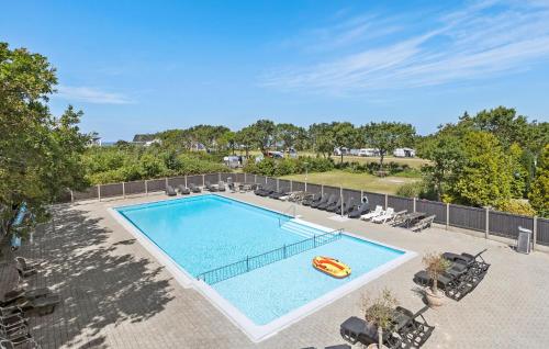 an overhead view of a swimming pool with a raft at Holiday Home Stikkelsbærvej Tarm Iv in Hemmet